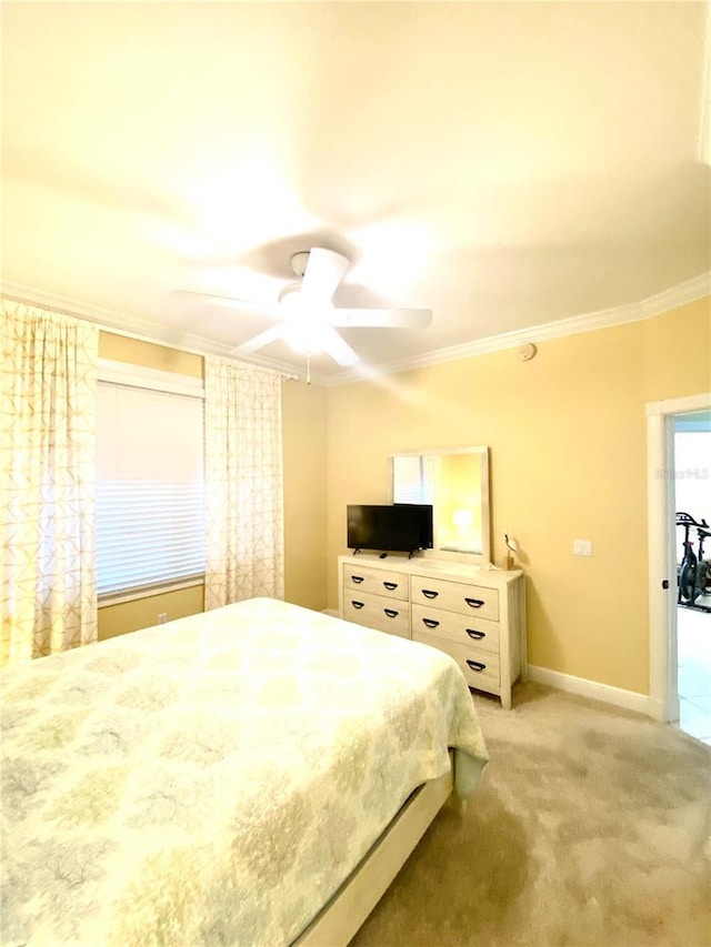 bedroom with light carpet, ceiling fan, baseboards, and ornamental molding