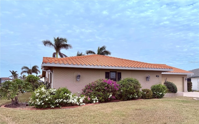 view of side of property featuring a yard and a garage