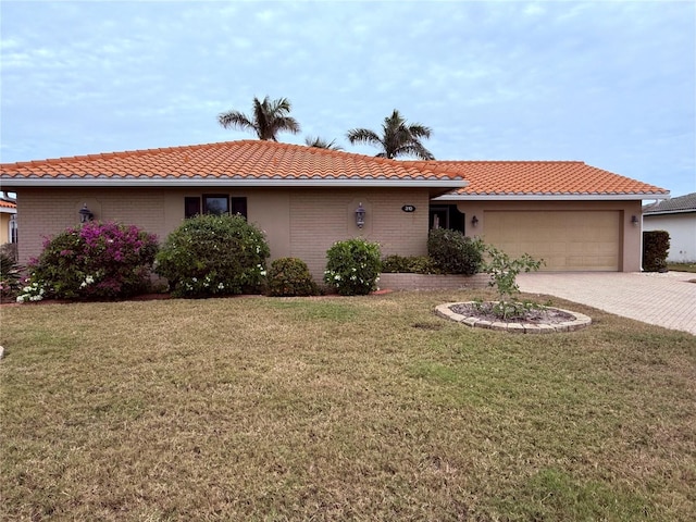 view of front of house with a garage and a front yard