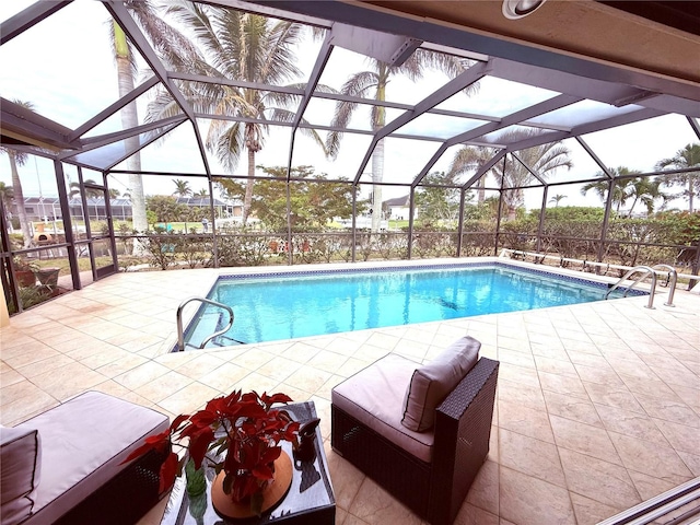 view of swimming pool featuring a lanai and a patio