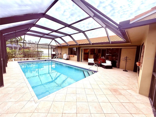 view of pool with an outdoor living space, a patio area, and a lanai