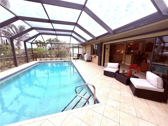 view of pool featuring glass enclosure, a patio area, and an outdoor living space