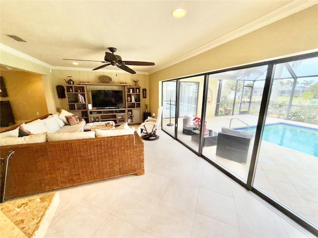 living room with tile patterned floors, ceiling fan, and ornamental molding