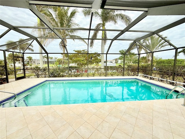 view of pool featuring glass enclosure and a patio area