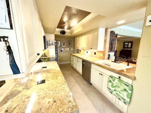 kitchen with sink, stainless steel appliances, light stone counters, a tray ceiling, and light tile patterned flooring