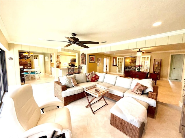 living room with ceiling fan and crown molding