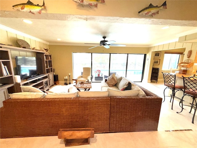 living room with ceiling fan and ornamental molding