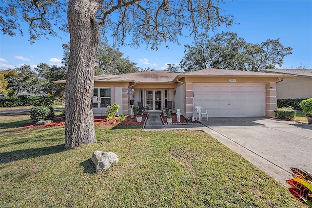 single story home featuring a garage and a front yard