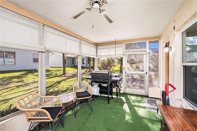 sunroom / solarium featuring ceiling fan