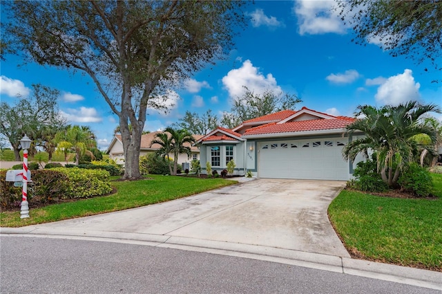 view of front of property with a garage and a front yard