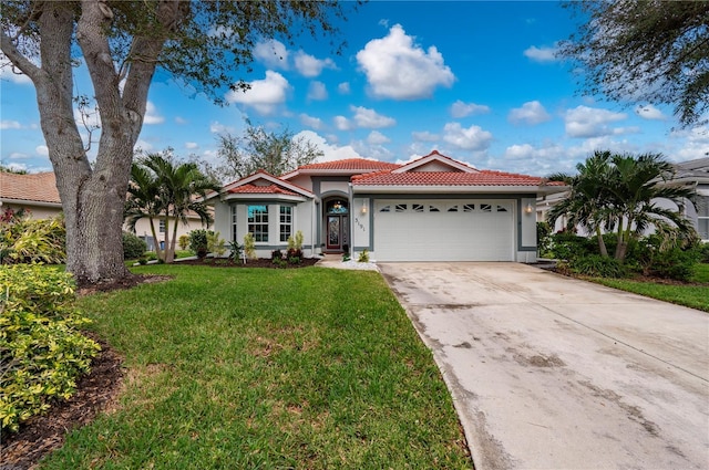 mediterranean / spanish house featuring a garage and a front lawn