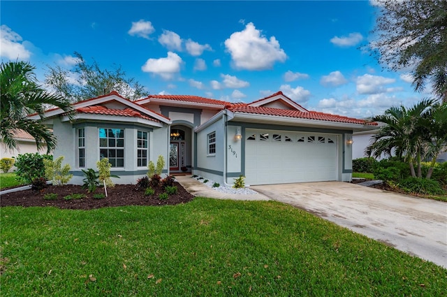 mediterranean / spanish house with a front yard and a garage