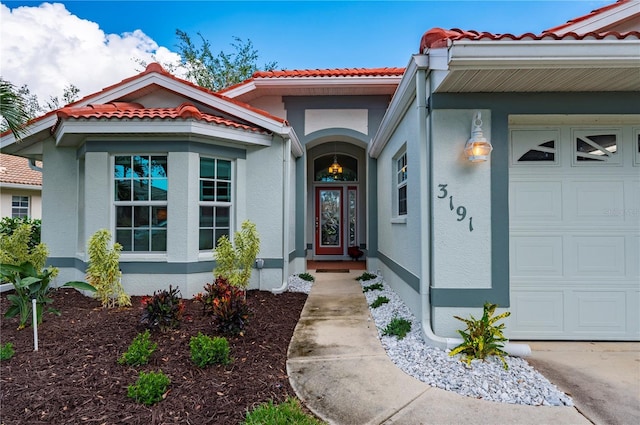 view of exterior entry featuring a garage