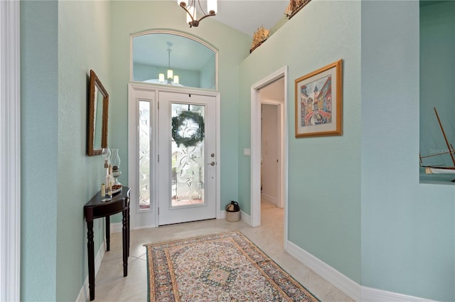 tiled entrance foyer featuring a chandelier