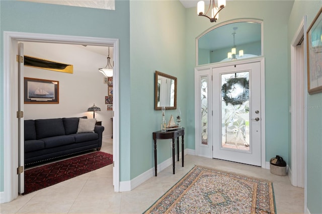 tiled foyer with a notable chandelier