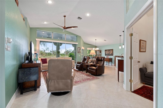 living room featuring light tile patterned floors, ceiling fan with notable chandelier, and lofted ceiling