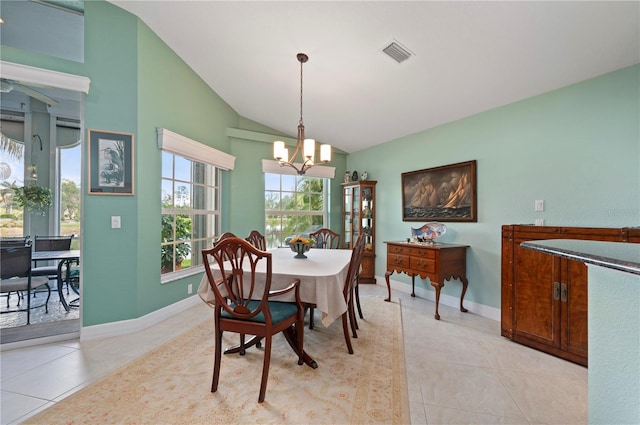 tiled dining area featuring lofted ceiling and a notable chandelier