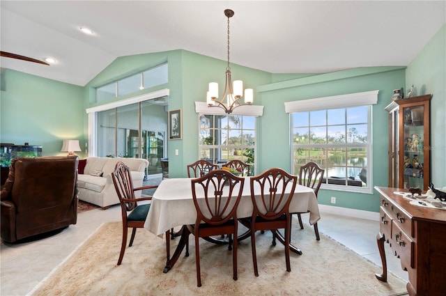 dining space featuring a water view, an inviting chandelier, and lofted ceiling