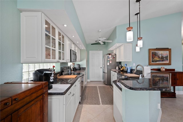 kitchen featuring appliances with stainless steel finishes, vaulted ceiling, sink, white cabinetry, and hanging light fixtures