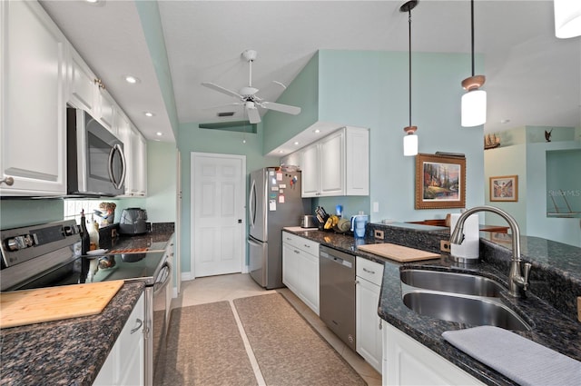 kitchen featuring hanging light fixtures, sink, white cabinets, and stainless steel appliances