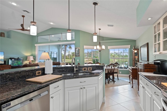 kitchen featuring sink, white cabinets, stainless steel dishwasher, and lofted ceiling