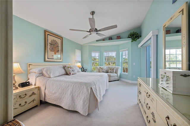 carpeted bedroom featuring ceiling fan, multiple windows, and vaulted ceiling