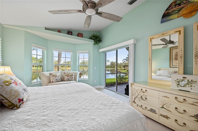 bedroom featuring access to exterior, vaulted ceiling, ceiling fan, a water view, and multiple windows