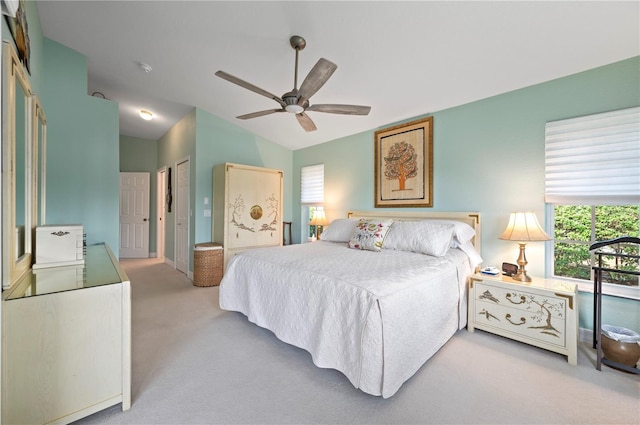 carpeted bedroom featuring vaulted ceiling and ceiling fan