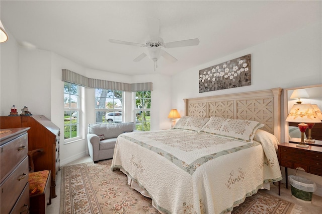 bedroom featuring light colored carpet and ceiling fan