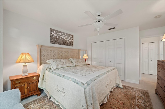 bedroom featuring light carpet, a closet, and ceiling fan