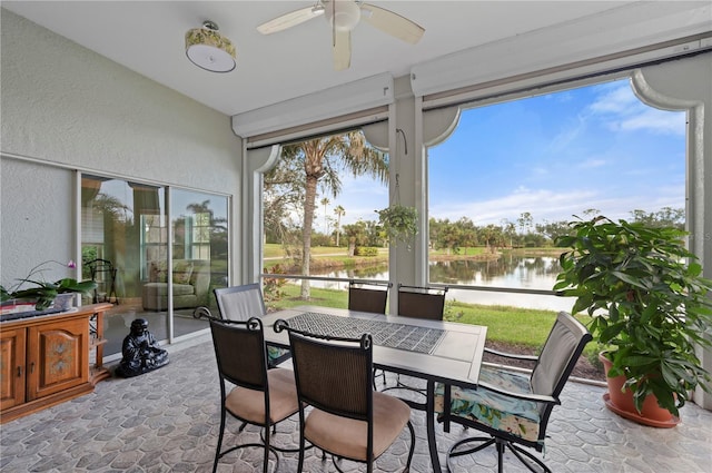 sunroom with a water view, plenty of natural light, and ceiling fan