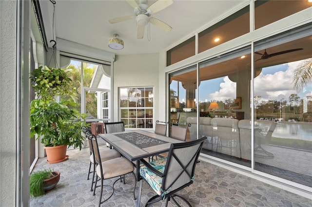 sunroom featuring ceiling fan