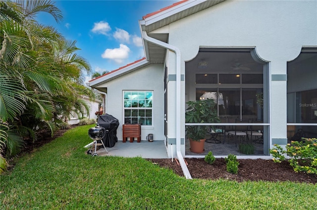 rear view of property featuring a yard and a patio area