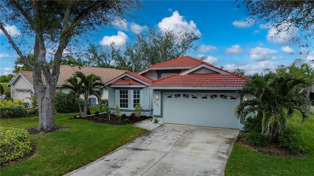 view of front of property featuring a front lawn and a garage