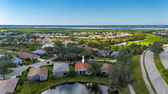 birds eye view of property with a water view