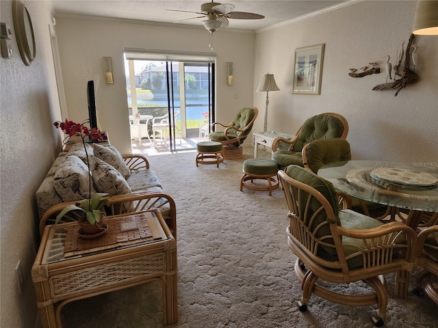 carpeted living room with ceiling fan and crown molding