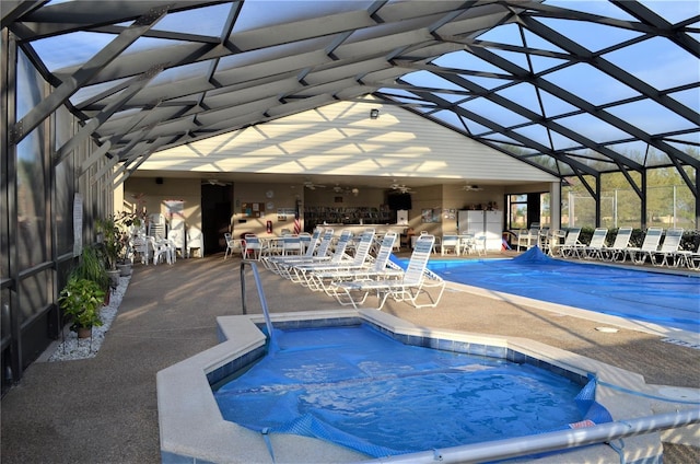 view of swimming pool with a patio, an outdoor bar, and glass enclosure