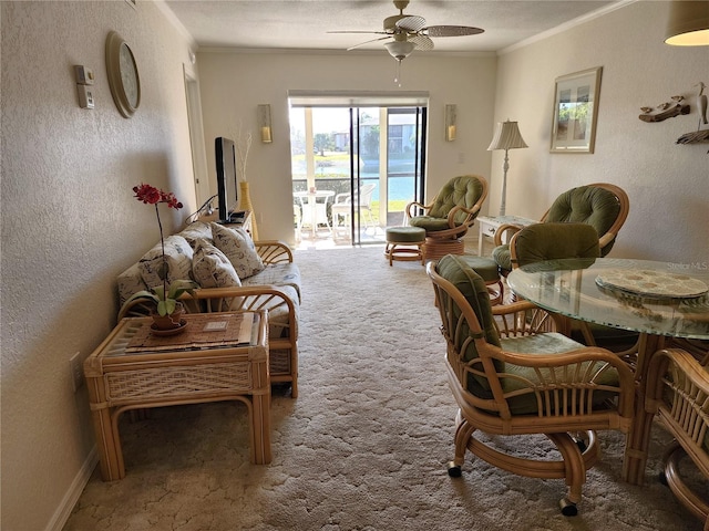 sitting room featuring crown molding, ceiling fan, and carpet