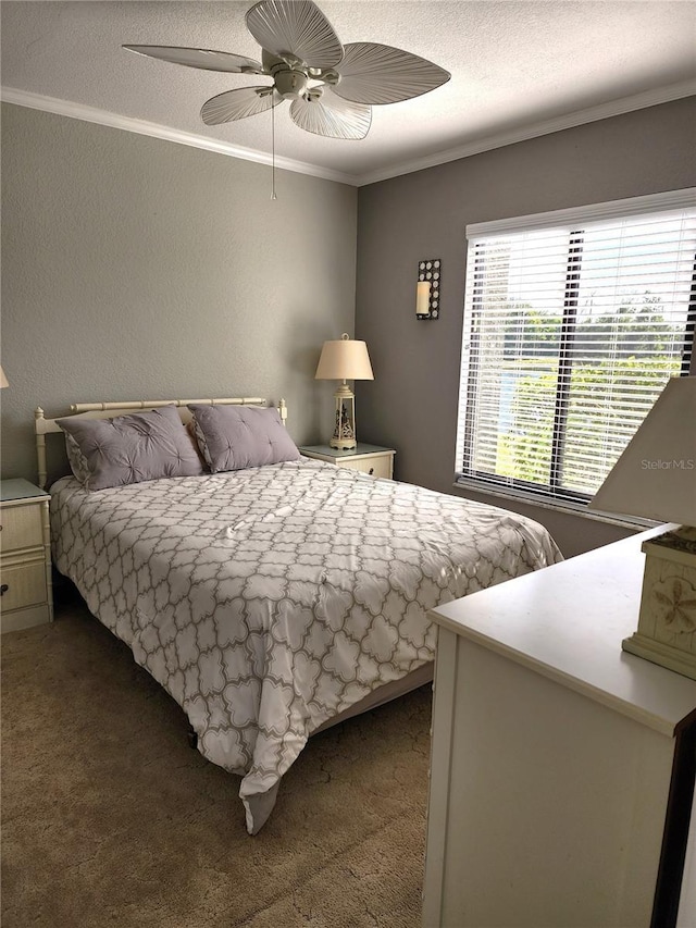 carpeted bedroom featuring ceiling fan, ornamental molding, and a textured ceiling