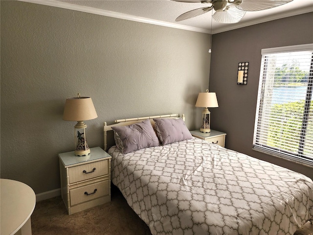 carpeted bedroom with ornamental molding and ceiling fan