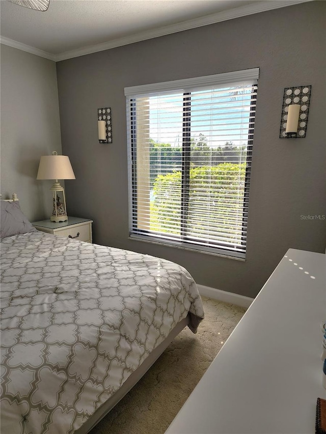 bedroom featuring ornamental molding and light colored carpet