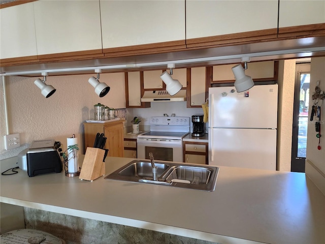 kitchen with sink and white appliances