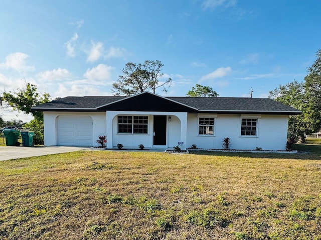 ranch-style house featuring a garage and a front lawn