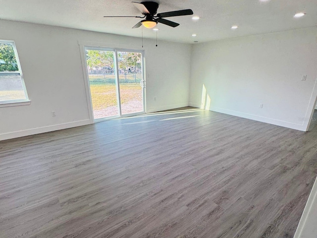 spare room with ceiling fan and wood-type flooring