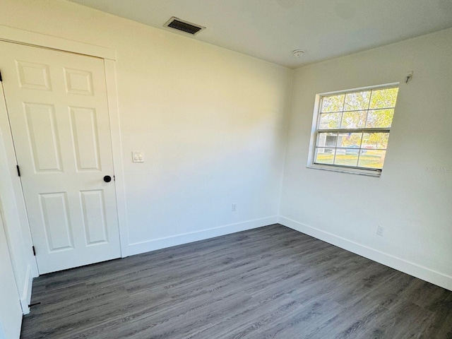 spare room with dark hardwood / wood-style floors