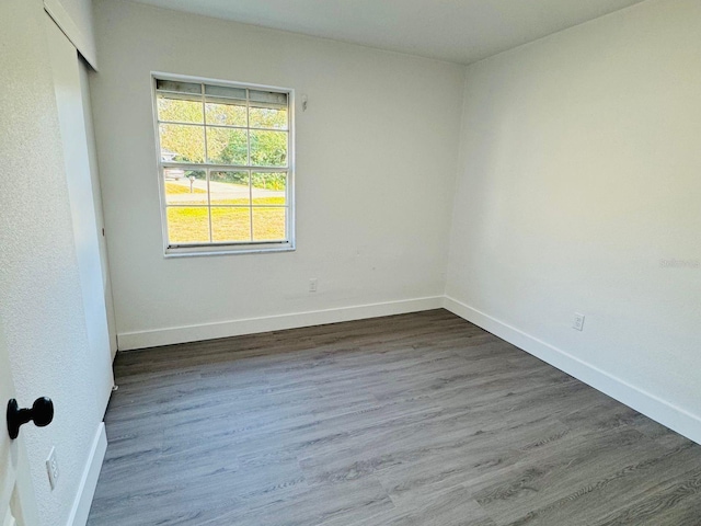 unfurnished room featuring dark hardwood / wood-style flooring