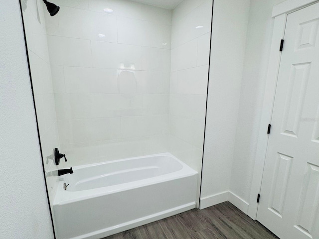 bathroom with hardwood / wood-style floors and  shower combination