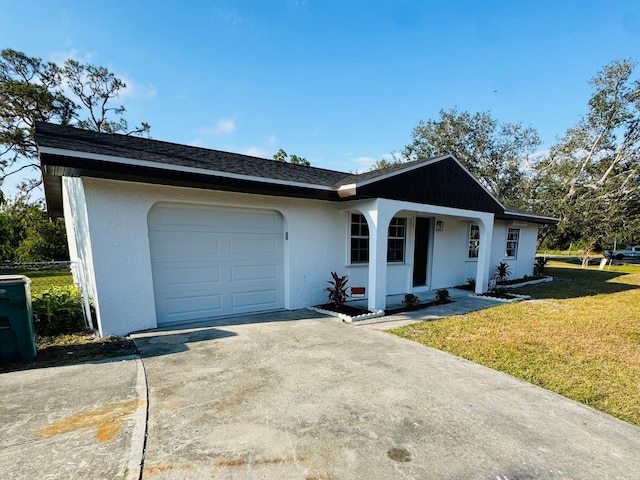 single story home with a front yard and a garage