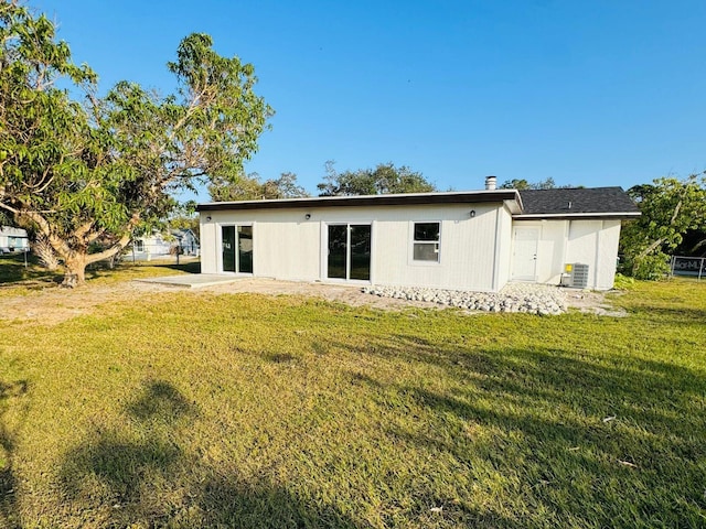 rear view of house with a yard