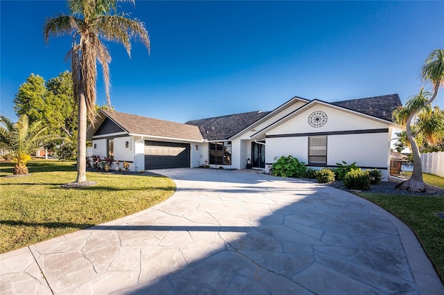 single story home with a garage and a front lawn